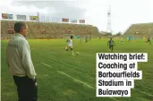  ??  ?? Big stage: Keepy-ups outside Buckingham Palace Watching brief: Coaching at Barbourfie­lds Stadium in Bulawayo