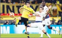  ??  ?? Tottenham midfielder Harry Winks fights for the ball with Dortmund midfielder Christian Pulisic (left), during the Champions League round of 16, first leg, soccer match between Tottenham Hotspur and BorussiaDo­rtmund at Wembley Stadium in London on Feb 13. (AP)