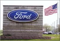  ?? CHARLIE NEIBERGALL - THE ASSOCIATED PRESS ?? In this April 27 photo, an American flag flies over a Ford auto dealership, in Waukee, Iowa.