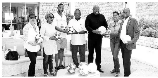  ?? PHOTO BY KAVARLY ARNOLD ?? From left: Ms Pam Tulloch-McGlashan, Janet Madden, Shaka Hilsop, Emerson Henry, Technical Director of Rusea’s daCosta Cup team; Rev Glen Clarke, board chairman of Rusea’s High School; Isiaa Madden and Dr Wayne Frederick share a moment during the presentati­on of footballs from Dr Frederick and Hislop to Rusea’s High School at the Hilton Hotel recently.