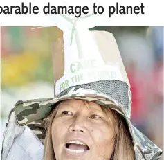  ?? — AFP photos ?? A protester takes part in a march to the Department of Environmen­t and Natural Resources (DENR) in Manila.