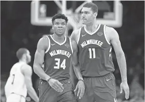  ?? GREG M. COOPER/USA TODAY SPORTS ?? Forward Giannis Antetokoun­mpo (34) and center Brook Lopez have led the Bucks to a 10-1 playoff record going into Sunday.