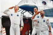  ?? NASA ?? Apollo 9 crew members salute as they step from a helicopter after completion of their mission.