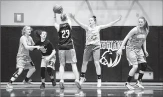  ?? Herald photo by Ian Martens ?? Amy Arbon looks to move the ball past Shantaya Strebel as Jaclyn Heggie, Jinan Daqqa and Shayna Mathison hold their position around the key during practice this week as the Lethbridge College Kodiaks women’s basketball team gets set to host the ACAC...
