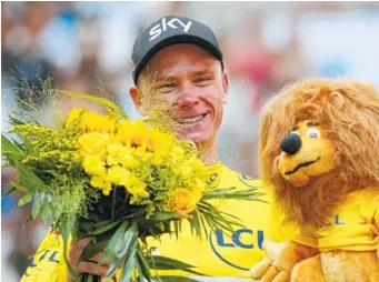  ?? THE ASSOCIATED PRESS ?? Britain’s Chris Froome, wearing the overall leader’s yellow jersey, celebrates on the podium after the 20th stage of the Tour de France on Saturday. Frrome shouild celebrate his fourth Tour title today.