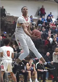  ?? PETE BANNAN — MEDIANEWS GROUP ?? West Chester East’s Tym Richardson spins to the net in the first quarter against Gettysburg Friday.