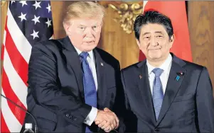  ??  ?? President Donald Trump, left, shakes hands with Japanese Prime Minister Shinzo Abe during a joint news conference at the Akasaka Palace in Tokyo on Monday. Trump is on a five-country trip through Asia traveling to Japan, South Korea, China, Vietnam and...