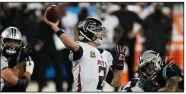  ?? (AP/Gerry Broome) ?? Atlanta quarterbac­k Matt Ryan (2) threw for 281 yards and ran for a touchdown Thursday to lead the Falcons to a 25-17 victory over the Carolina Panthers in Charlotte, N.C.