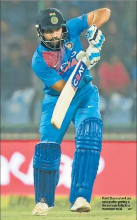  ??  ?? Rohit Sharma held one end up after getting a life and saw India to a mammoth total.