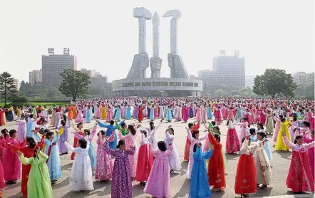  ??  ?? Colourful show of patriotism: Members of the North Korean women’s union holding a dance party at the plaza of the Monument to Party Founding in Pyongyang to celebrate the country’s 69th founding anniversar­y. — AFP
