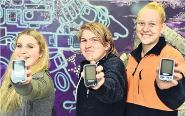  ?? PHOTOS: GREGOR RICHARDSON ?? Painfree future . . . Diabetes research project participan­ts Olivia Larkins (17), Brad England (17) and Brooke Helms (18), all of Dunedin, with the glucose monitoring device they will be testing.