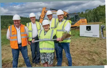  ??  ?? Above: Margaret Davidson with (L-R): Stephen McCaig, Marine Harvest constructi­on manager, John Richmond, freshwater manager, Steve Bracken, business support manager, and Mick Watts, group engineer