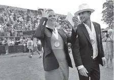  ?? THE ASSOCIATED PRESS ?? Inductees Kim Clijsters and Andy Roddick laugh as they walk around center court to acknowledg­e fans during Saturday’s enshrineme­nt ceremonies at the Internatio­nal Tennis Hall of Fame.