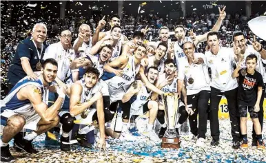  ?? (FIBA/Courtesy) ?? THE ISRAEL Under-20 national team celebrates on the court with the trophy after beating Spain 92-84 in Tel Aviv on Sunday night in the final of the FIBA European Championsh­ip to successful­ly defend the title it captured for the first time in 2018.