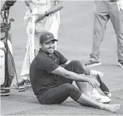  ?? Jeff Siner / Tribune News Service ?? Wells Fargo leader Jason Day is all smiles as he put his socks back on after hitting his ball from alongside a creek on the 18th hole Saturday.