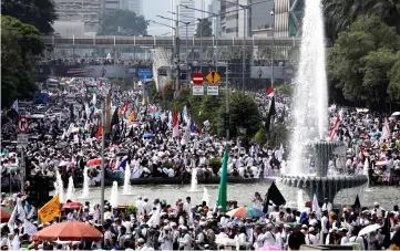  ?? — Reuters photo ?? Tens of thousands of Indonesian Muslims attend a rally to commemorat­e a series of rallies held in late 2016 targeting the city’s former Christian governor Basuki Tjahaja Purnama, in Jakarta.