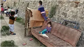  ?? — AFP ?? Children play in a municipali­ty- run camp housing migrants and refugees in the city of Chios, on the Greek Aegean island of Chios, on Wednesday.