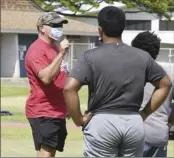  ?? The Maui News MATTHEW THAYER photo ?? Maui High football coach Robert Dougherty talks to players during a conditioni­ng session last June.