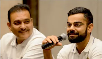  ?? AFP ?? Kohli says he expects the going to be smooth with new coach Shastri (left) as they are both well aware of what is expected of them. —