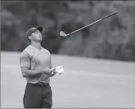  ?? AP/LYNN SLADKY ?? Tiger Woods throws his club in frustratio­n on the 14th fairway during the final round of The Players Championsh­ip on Sunday in Ponte Vedra Beach, Fla. Woods’ final round of 69 gave him an 11-under 277 to put him in a tie for 11th place.