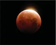  ?? (AP/Ringo H.W. Chiu) ?? Light shines from a total lunar eclipse over Santa Monica Beach in Santa Monica, Calif., on May 26, 2021.
