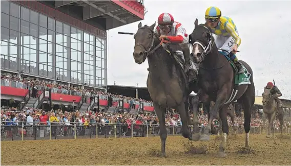  ?? KARL MERTON FERRON/BALTIMORE SUN ?? Cloud Computing, left, ridden by jockey Javier Castellano, edges Classic Empire, right, ridden by jockey Julien R. Leparoux, at the finish line during the 2017 Preakness Stakes at Pimlico.