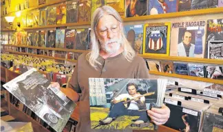  ??  ?? John Dunning, owner of Trolley Stop Record Shop, 1807 N Classen, talks about country music legend Merle Haggard and his influence on the musical styles of a number of Oklahoma artists. Haggard died Wednesday at age 79 at his home in North Carolina.