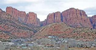  ?? RICK BOWMER/ASSOCIATED PRESS FILE PHOTO ?? Hildale, Utah, at the base of Red Rock Cliff mountains, with its sister city, Colorado City, Ariz., in the foreground in 2014. On Tuesday, a businessma­n pleaded guilty to conspiring with the leader of an offshoot polygamous sect to transport underage girls across state lines for sexual activity.