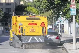  ?? Gina Ferazzi Los Angeles Times ?? A STREET sweeper in Hollywood in 2014. Most L.A. streets are swept when employees get to them or when someone complains, Controller Ron Galperin wrote.