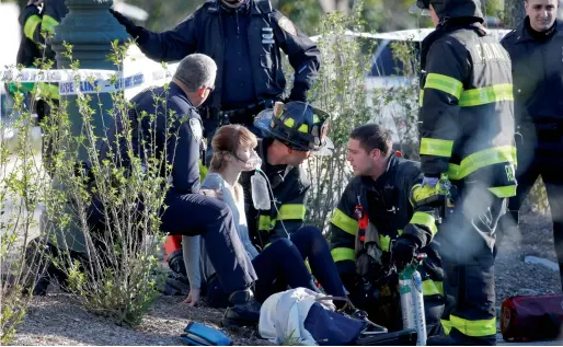  ?? Reuters ?? A woman is aided by first responders after sustaining injuries on a bike path in lower Manhattan, New York. —