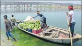  ?? HT PHOTO ?? ▪ A farmer’s family ferrying vegetables across the Ganga on boats after harvesting them from their field on the banks of the river in Phaphamau.