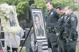  ?? Irfan Khan Los Angeles Times ?? RESPECTS ARE paid to Whittier Officer Keith Boyer at a memorial. Michael Christophe­r Mejia is accused of gunning down Boyer and injuring another officer.