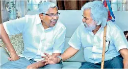  ??  ?? Telangana Jana Samiti president and Mahakutami convenor Kodandaram along withballad­eer Gaddar at a meeting on Monday.