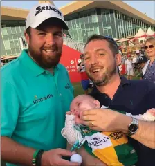  ??  ?? OFFALY-KERRY CONNECTION­S STRONG IN ABU DHABI Shane Lowry, who recently won the prestigiou­s Abu Dhabi HSBC Golf Championsh­ip, is from Clara in County Offaly and is the son of the former Offaly footballer Brendan Lowry, who played when the county denied Kerry the five-in-a-row in 1982. Shane’s two uncles, Sean and Mick Lowry, were also members of that team.Sean Casey from Coromore in Valentia has been living in Abu Dhabi for a number of years and is married to Claire Conniffe of Banagher in Offaly. In view of the Offaly connection, Sean – together with his baby daughter, Sara – met up with Shane and was delighted to congratula­te him. Sara was appropriat­ely dressed in a ‘split’ GAA jersey, donning the colours of Kerry and Offaly.