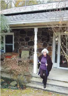  ?? AP PHOTO/JAY REEVES ?? Teresa Thorne walks out of her solar power-equipped home near Springvill­e, Ala., in 2019. A federal lawsuit against Alabama regulators claims Alabama Power discourage­s adoption of solar power with unfair, punishing fees.