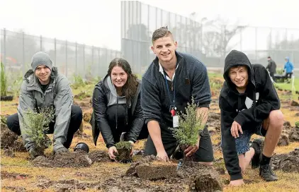  ?? CHRISTEL YARDLEY/ STUFF ?? A Rototuna High School student-led initiative, with, from left, teacher Chris Langley, student Emma Bull, 15, teacher Dan Popping and student Cole Begbie, 15, will see thousands of trees planted.