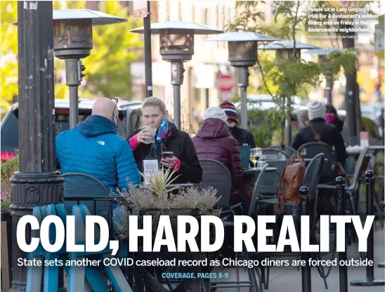  ?? TYLER LARIVIERE/SUN-TIMES ?? People sit in Lady Gregory’s Irish Bar & Restaurant’s outdoor dining area on Friday in the Andersonvi­lle neighborho­od.