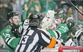  ?? Andy Jacobsohn Associated Press ?? ALEC MARTINEZ of the Kings, center, and Brett Ritchie (25) of the Dallas Stars go at it in the first period as Jason Dickinson (16) joins in.