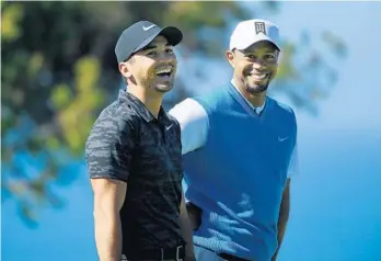  ?? DONALD MIRALLE/GETTY IMAGES ?? Former No. 1 Jason Day, left, has struck up a friendship with another former No. 1, Tiger Woods, who has helped him through difficult times. They are paired together in the first two rounds this week.