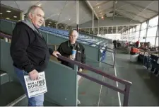  ?? NATI HARNIK — THE ASSOCIATED PRESS ?? Ron Tenski and Jerry Moritz, left, who had arrived to Fonner Park in Grand Island, Neb., for Saturday’s horse races, leave after the races were called off due to dangerous track conditions following snowfall.