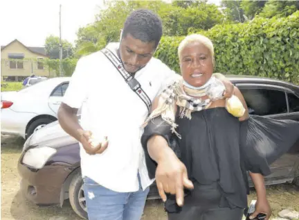  ?? (Photos: Alan Lewin) ?? A distressed Romario Murray and his mother, Almena Martin, outside Noel Holmes Hospital in Lucea, Hanover, on Wednesday.