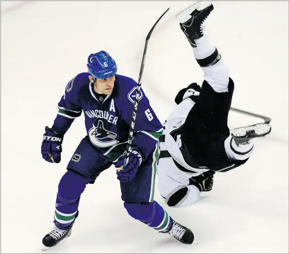  ?? STEVE BOSCH/PNG FILES ?? Playing for Vancouver in the 2012 playoffs, Sami Salo upends Los Angeles Kings’ Mike Richards. Even though Salo was just a No. 3 defenceman, the Canucks were always a better team with him in the lineup.