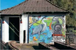  ?? ?? Gone to the wall: The colourful mural at the Strathaven Miniature Railway's station celebrates the line's new celebrity status as Scotland's oldest miniature railway. HUGH DOUGHERTY