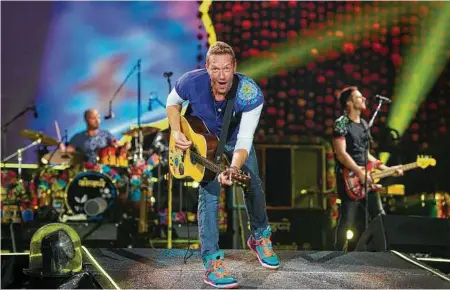  ?? Scott Roth / Associated Press ?? Coldplay dedicated a one-off song to the people of Houston during a show in Miami.