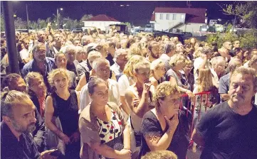  ??  ?? Residents of Saint-Barthélemy gather to pay a last tribute to French music icon Johnny Hallyday before his burial during the public wake at the Saint John Funeral Home on Dec 10. — AFP photo