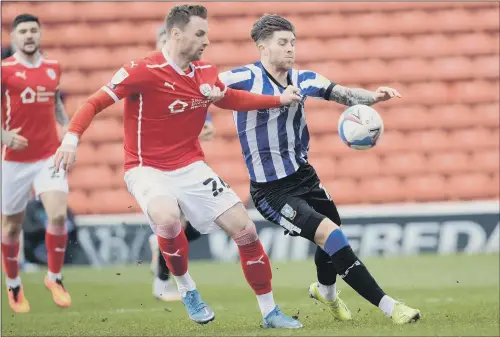  ?? FROM SURVIVAL BATTLE TO PROMOTION CHARGE: PICTURE: STEVE ELLIS ?? Barnsley’s Michael Sollbauer, up against Sheffield Wednesday’s Josh Windass, is loving the challenge.