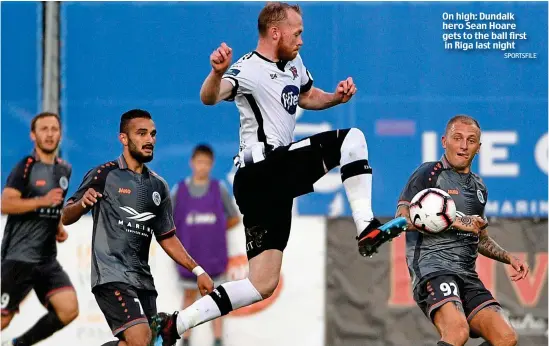  ?? SPORTSFILE ?? On high: Dundalk hero Sean Hoare gets to the ball first in Riga last night