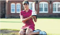  ?? PHOTO: REUTERS ?? Georgia on my mind . . . England’s Georgia Hall holds the trophy after winning the Women’s British Open at Royal Lytham and St Annes yesterday.