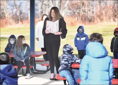  ?? Brian A. Pounds / Hearst Connecticu­t Media ?? Shelton’s Director of Curriculum Kristen Santilli reads to students in Tracey Sedlock's first-grade class in the outdoor classroom at Mohegan School in Shelton on Jan. 19.