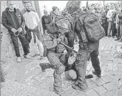  ?? ?? Israeli security forces immobilise a Palestinia­n man near the Al-Aqsa mosque compound in Jerusalem on Friday.